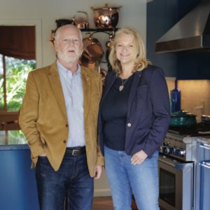 man and women standing in kitchen
