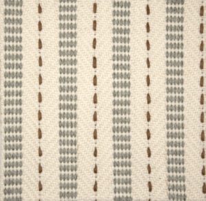 STANTON Miles-Lagoon: “Stanton weaves grey yarn and light brown leather onto luminous peach flatweave carpet”